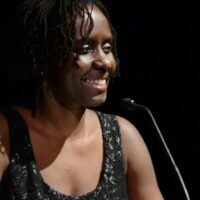 Juliane Okot Bitek onstage with a microphone
